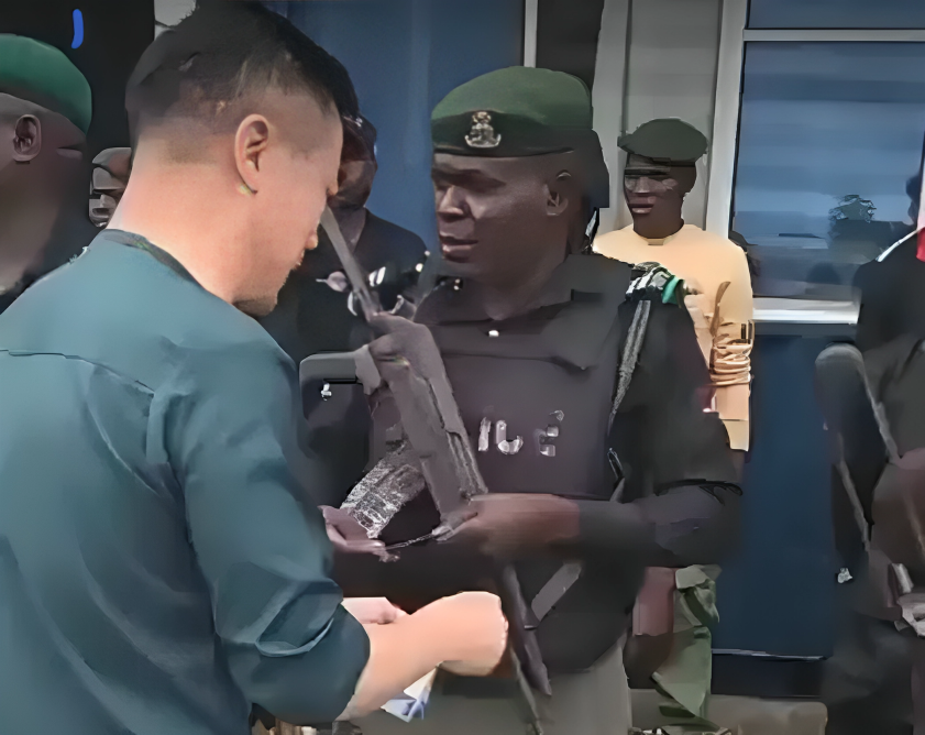 chinese national giving money to a police officer 1045x830 1